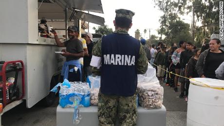 Members of the Mexican navy have set up mobile kitchens to feed migrants.