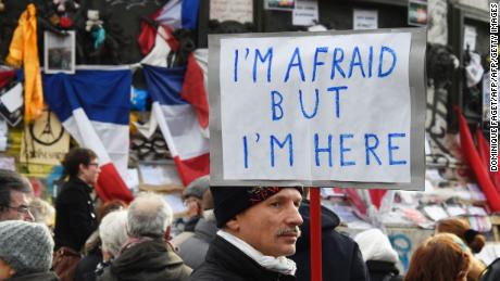 A man holding a placard reading &quot;I am afraid but I am here&quot; during a gathering on Place de la Republique (Republic square) on January 10, 2016 in Paris, as the city marks a year since 1.6 million people thronged the French capital in a show of unity after attacks on the Charlie Hebdo newspaper and a Jewish supermarket. Just as it was last year, the vast Place de la Republique is the focus of gatherings as people reiterate their support for freedom of expression and remember the other victims of what would become a year of jihadist outrages in France, culminating in the November 13 coordinated shootings and suicide bombings that killed 130 people and were claimed by the Islamic State (IS) group. DOMINIQUE FAGET/AFP/Getty Images
