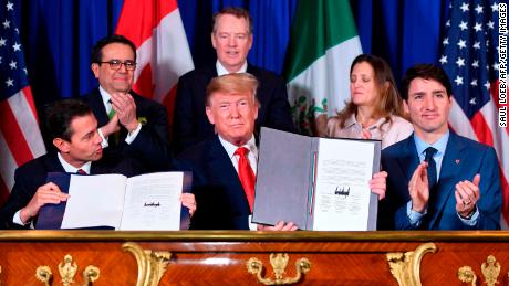 Mexico&#39;s President Enrique Pena Nieto (L) US President Donald Trump (C) and Canadian Prime Minister Justin Trudeau, sign a new free trade agreement in Buenos Aires, on November 30, 2018, on the sidelines of the G20 Leaders&#39; Summit. - The revamped accord, called the US-Mexico-Canada Agreement (USMCA), looks a lot like the one it replaces. But enough has been tweaked for Trump to declare victory on behalf of the US workers he claims were cheated by NAFTA. (Photo by SAUL LOEB / AFP)        (Photo credit should read SAUL LOEB/AFP/Getty Images)