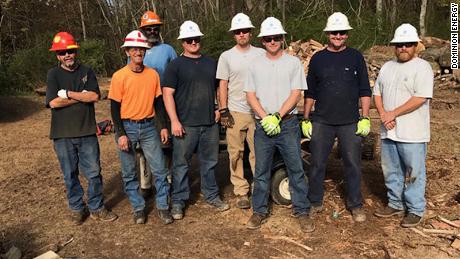 A construction crew from Dominion Energy helped college students turn downed trees into firewood for families in need in Farmville, Virginia, which was hit hard by Hurricane Michael in October.