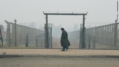 Glassman walks at the gates of Auschwitz, a Nazi concentration camp, where he said he heard souls' voices clamoring to be remembered. Photo by Peter Cunningham. 