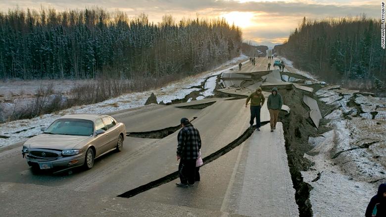 People walk along a road in Wasilla after Friday's earthquake.