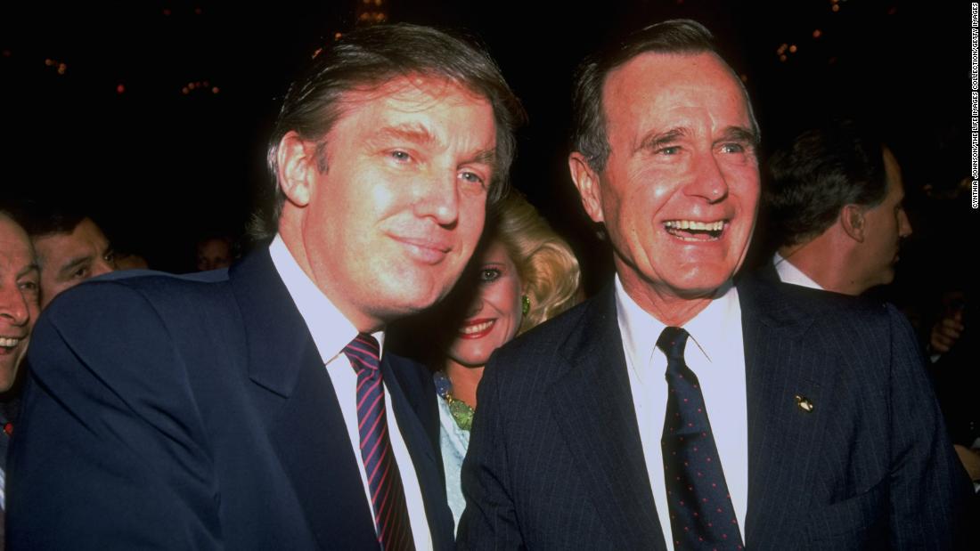 Bush poses for a photo with real estate mogul and future President Donald Trump during a campaign event in 1988.