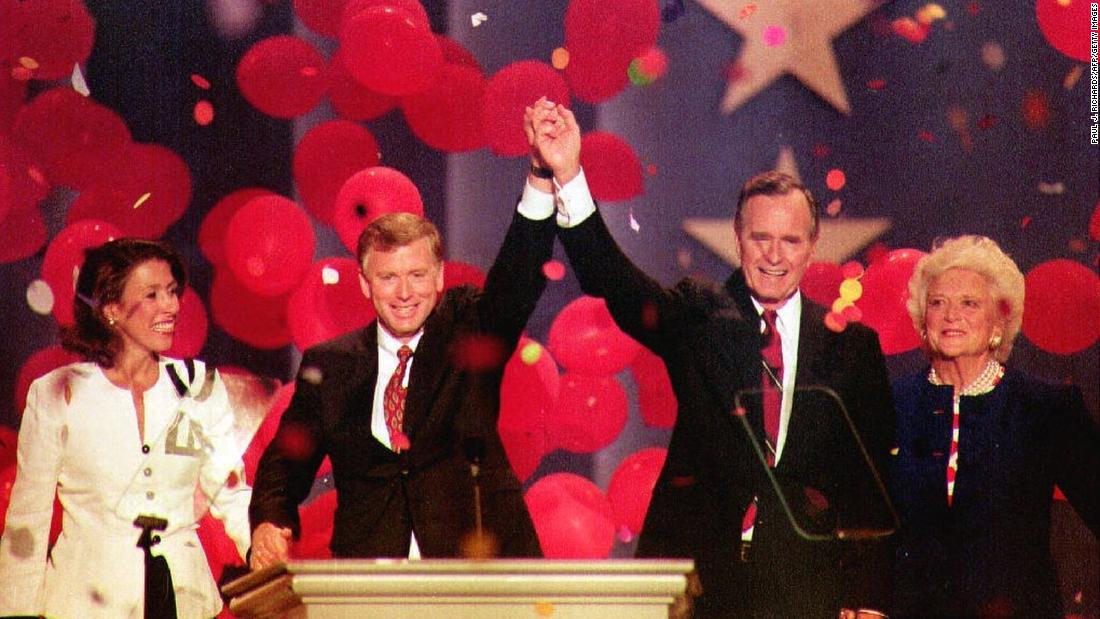 Bush and Vice President Dan Quayle join hands at the 1992 Republican National Convention in Houston. They are joined by their wives, Marilyn Quayle and Barbara Bush.