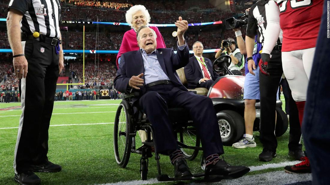 The Bushes participate in the ceremonial coin toss before the Super Bowl in 2017. 