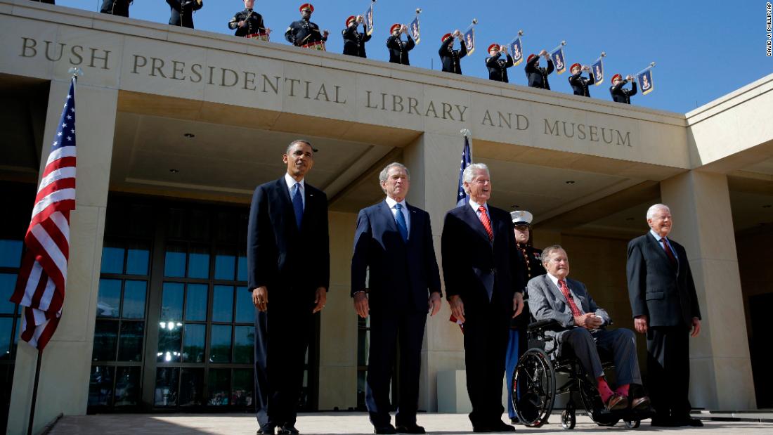 Bush, in the wheelchair, arrives for the dedication of his son&#39;s presidential library in Dallas in 2013. Joining him, from left, are President Barack Obama and former Presidents George W. Bush, Bill Clinton and Jimmy Carter.