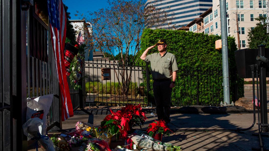 A veteran salutes Bush at a memorial outside Bush&#39;s home in Houston on December 1.
