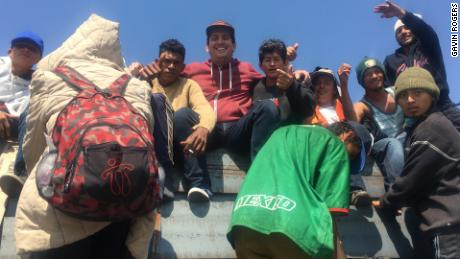 Pastor Gavin Rogers, in the red sweatshirt, center, traveling with the migrant caravan.