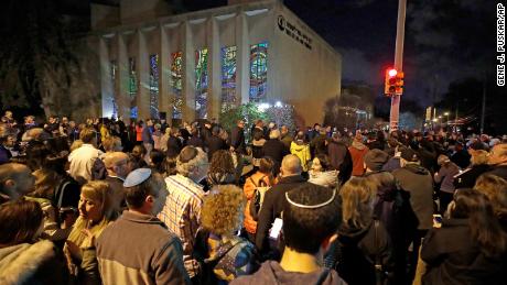 A crowd gathers outside the Tree of Life Synagogue on Sunday, the first night of Hanukkah.