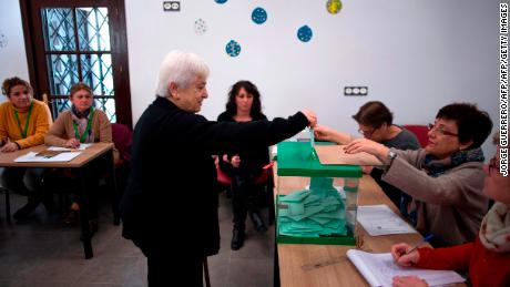 A woman casts her vote at a polling station in Carratraca near Malaga on December 2, 2018 during Andalusia&#39;s regional election. 