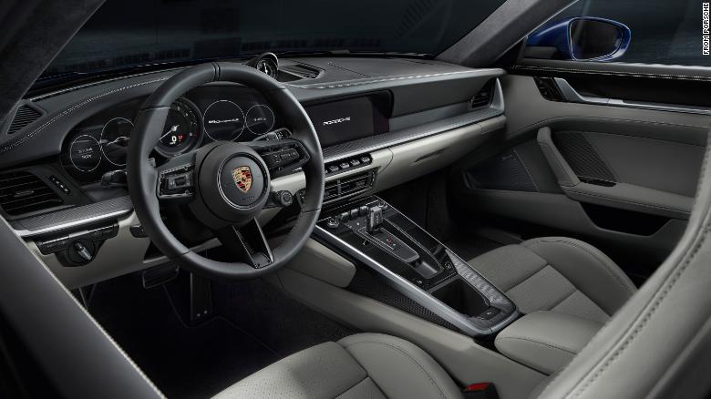 The new Porsche 911&#39;s interior has a cleaner look thanks to touch screens replacing many of the knobs and switches.