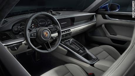 The new Porsche 911's interior has a cleaner look thanks to touch screens replacing many of the knobs and switches.