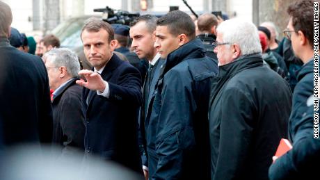 French President Emmanuel Macron waves as he leaves the Cafe Belloy, near the Arc de Triomphe in Paris on Sunday.