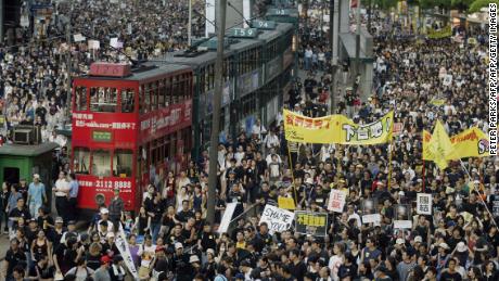 Trams sit stranded as hundreds of thousands of people block the streets in a huge protest march against a controversial anti-subversion law known as Article 23 in Hong Kong in 2003. 