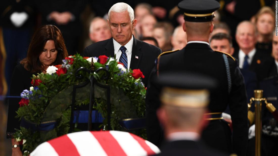 Vice President Mike Pence and his wife, Karen, pause near Bush&#39;s casket on December 3.