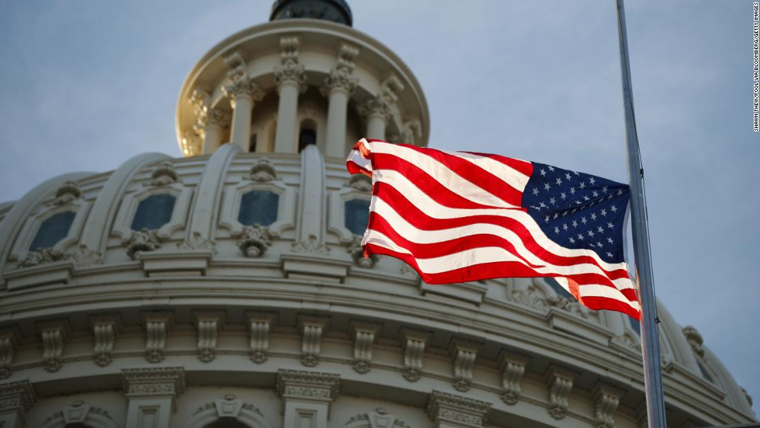 The American flag flies at half-staff at the US Capitol on December 3.