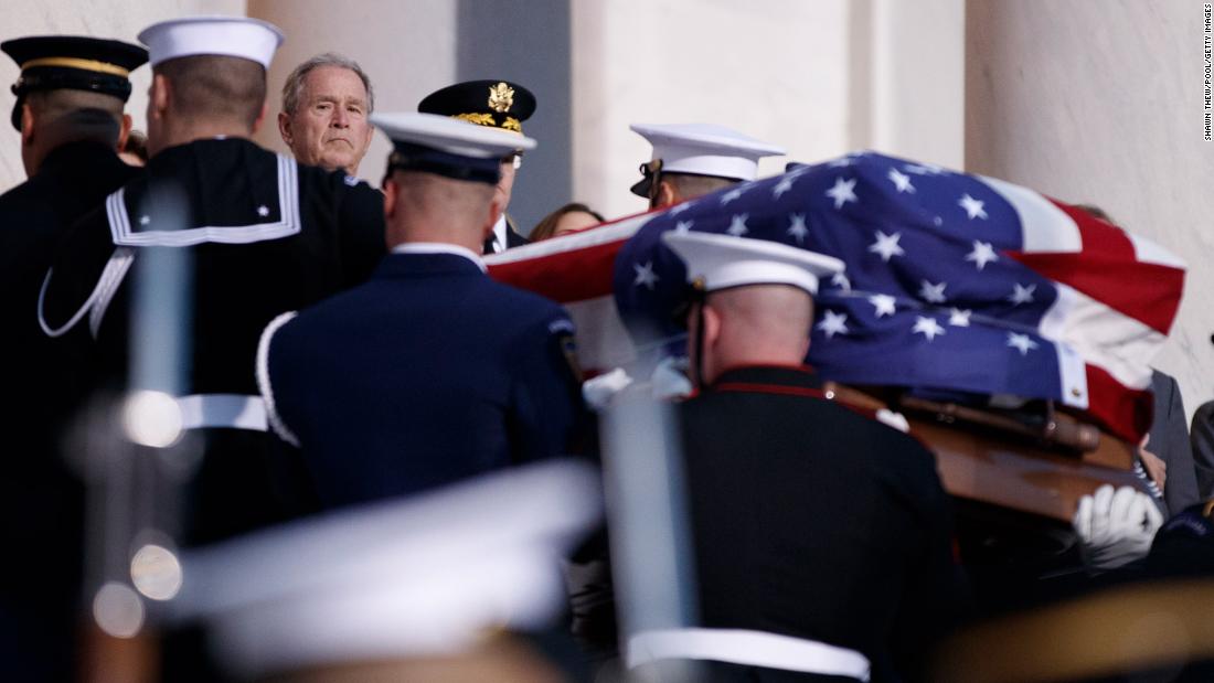 Former President George W. Bush watches his father&#39;s casket arrive at the Capitol on December 3.