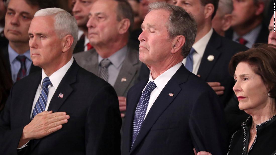 From left, Vice President Mike Pence, former President George W. Bush and former first lady Laura Bush watch the late President&#39;s casket arrive at the US Capitol rotunda on Monday, December 3.