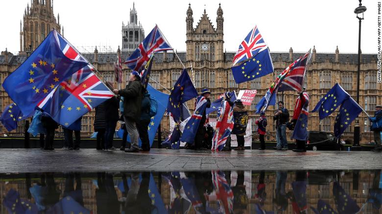 Anti-Brexit protesters wave EU flags outside Parliament.