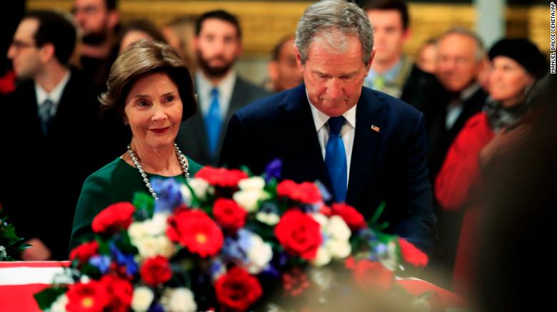 Former President George W. Bush and former first lady Laura Bush pay their respect to his father former President George H.W. Bush as he lie in state at the U.S. Capitol in Washington, Tuesday, Dec. 4, 2018. (AP Photo/Manuel Balce Ceneta)