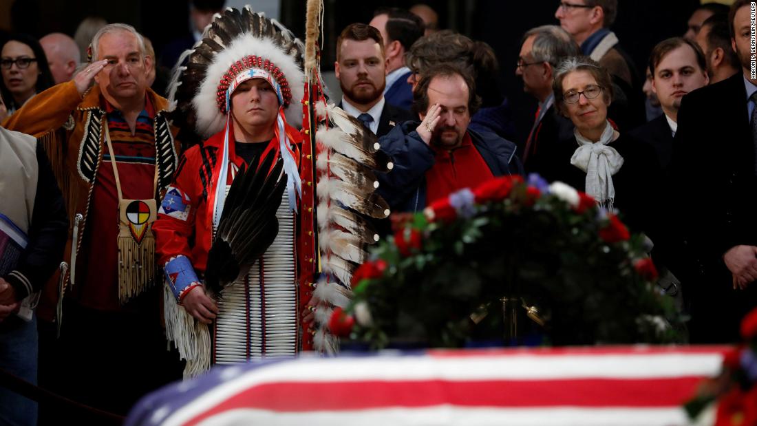 Warren Stade, left, and Donald Woody, second left, say goodbye to Bush on December 4. They are Native Americans of the Shakopee Mdewakanton Sioux Community tribe in Prior Lake, Minnesota.