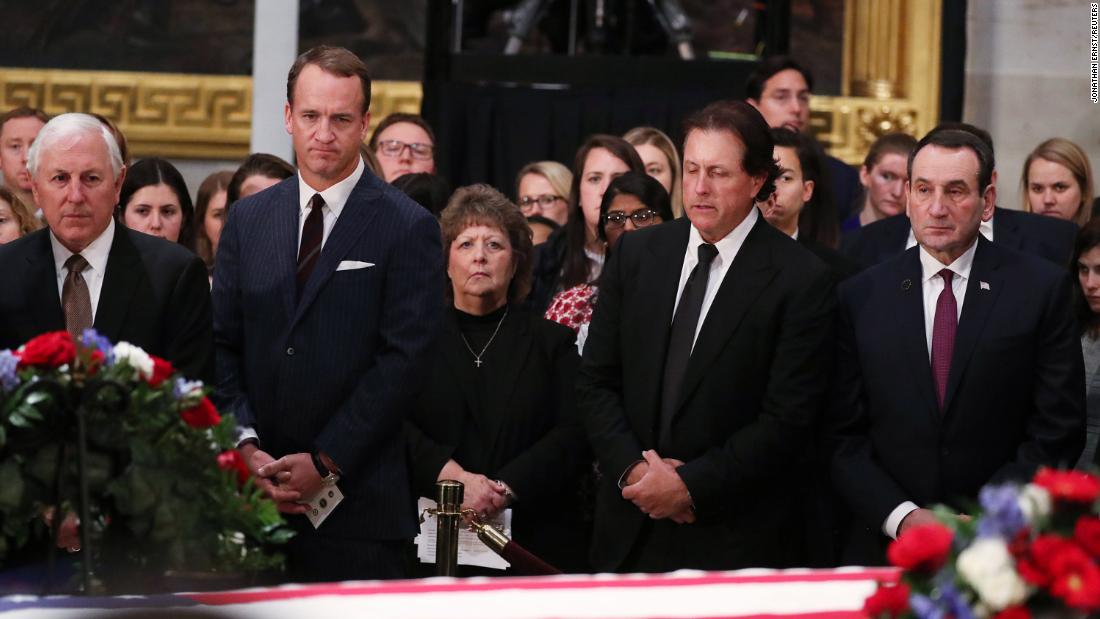 From left, retired golfer Hale Irwin, former NFL quarterback Peyton Manning, golfer Phil Mickelson and Duke basketball coach Mike Krzyzewski pay their respects on December 4.