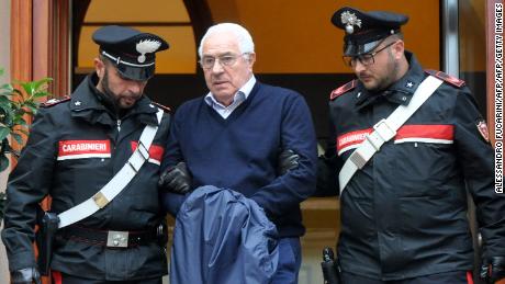 Settimo Mineo, center, jeweller and alleged new head of the Sicilian Mafia, Cosa Nostra, is escorted out of a police station after his arrest in Palermo on Tuesday.