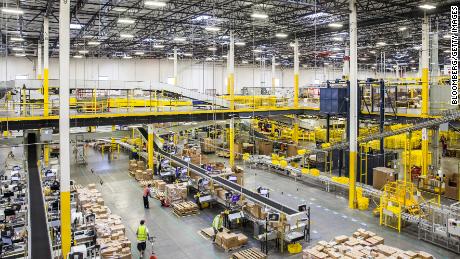 Employees move packages inside an Amazon fulfillment center in Robbinsville, New Jersey, on Nov. 28, 2016.