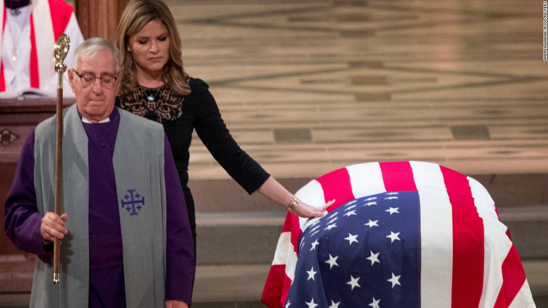 Jenna Bush Hager, one of the late President&#39;s granddaughters, touches his casket at the funeral.