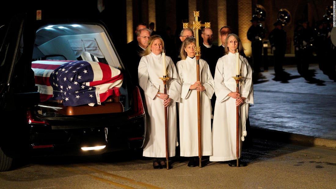 Church members wait next to the hearse during the arrival of Bush&#39;s casket on December 5.