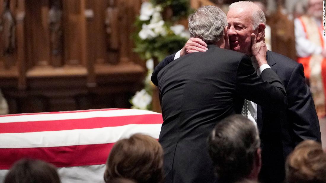 Former President George W. Bush embraces his father&#39;s close friend, former Secretary of State James Baker, after giving a eulogy in Houston on December 6.