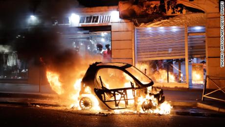 A car burns during violent protests last weekend in Paris.