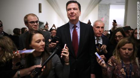 Former Federal Bureau of Investigation Director James Comey is surrounded by reporters after testifying to the House Judiciary and Oversight and Government Reform committees at the Rayburn House Office Building on Capitol Hill December 7, 2018, in Washington, DC. 