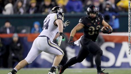 Darnell Woolfolk of the Army Black Knights carries the ball as Navy's Taylor Heflin defends at Lincoln Financial Field in Philadelphia.