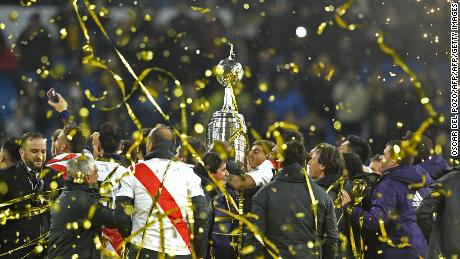 River Plate celebrates with the trophy after winning the second leg of the all-Argentine Copa Libertadores final.