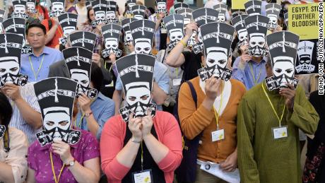 Amnesty International activists protest against sexual violence against women and against the bloodshed in Egypt, in Berlin, Germany, 19 August 2013. 