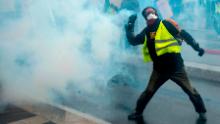 A protester throws a part of a tear gas canister during a protest of &quot;yellow vests&quot; (gilets jaunes) against rising costs of living they blame on high taxes in Nantes, eastern France on December 8, 2018. - French &quot;yellow vest&quot; demonstrators clashed with riot police in Paris on December 8, 2018 in the latest round of protests against President Emmanuel Macron, but the city appeared to be escaping the large-scale destruction of a week earlier due to heavy security. (Photo by Sebastien SALOM-GOMIS / AFP)        (Photo credit should read SEBASTIEN SALOM-GOMIS/AFP/Getty Images)