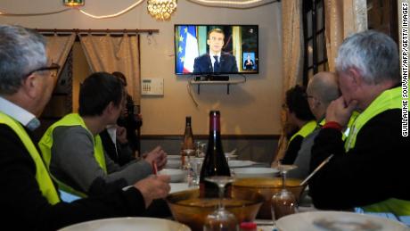 Yellow vest protesters watch Macron&#39;s address to the nation on Monday night. 