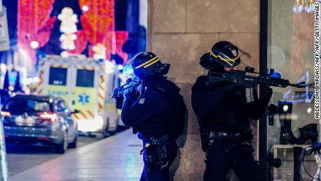 French police officers stand guard near the scene of the shooting on Tuesday.