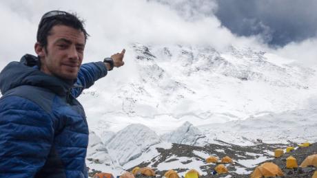 Kilian Jornet points to the summit of Mt. Everest.