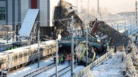 Rescue workers search through wreckage after a high-speed train crash Thursday in Ankara, Turkey.