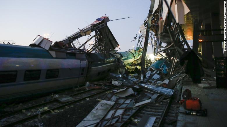 Rescuers evacuate injured passengers after the high-speed train crash Thursday.