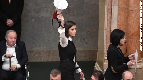One member of parliament brandishes an air horn in parliament following the vote.