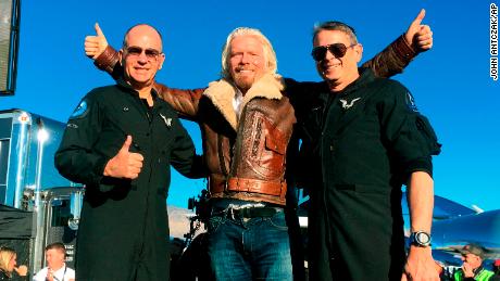 Richard Branson celebrates with pilots Rick "CJ" Sturckow, left, and Mark "Forger" Stucky, right, after Virgin Galactic's tourism spaceship climbed more than 50 miles high.