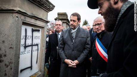 French Interior Minister Christophe Castaner, center, attends a ceremony at the Jewish cemetery of Herrlisheim with Strasbourg Rabbi Harold Weill, right, and Herrlisheim Mayor Louis Becker, second from right.