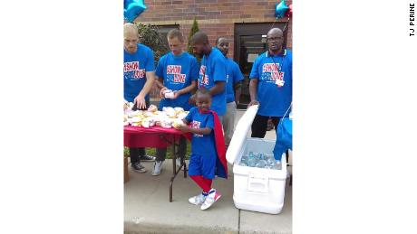 Austin Perine travels to Detroit to feed the homeless in his superhero red cape. 