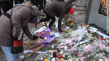 People lay flowers in tribute to the victims of Cherif Chekatt, on December 14, 2018 at Strasbourg's Christmas market, one day after after French police shot him dead. 