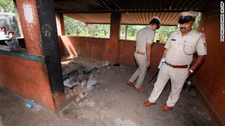 Indian policeman inspect the kitchen of a temple on Saturday after the incident.