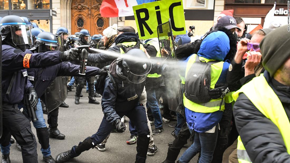 Police use tear gas on protesters at the Place de l&#39;Opera in Paris on December 15.