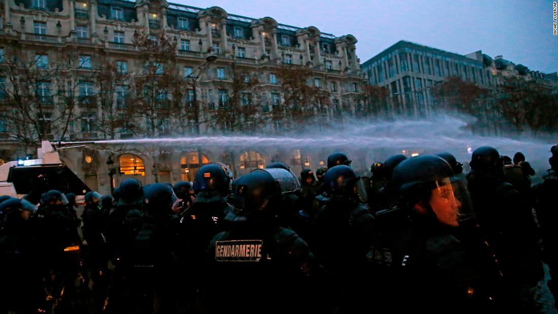 A police water cannon sprays demonstrators on December 15 in Paris.
